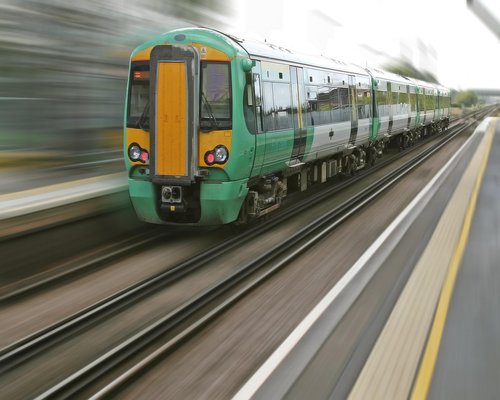 A public transit window perspective displaying urban motion blur within a typical day commute