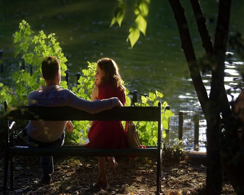 People sitting in a bright airy polish cafe enjoying gentle afternoon conversation shadow plays