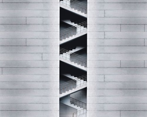 Minimalist geometric architectural layout of building stairs from a lower perspective view